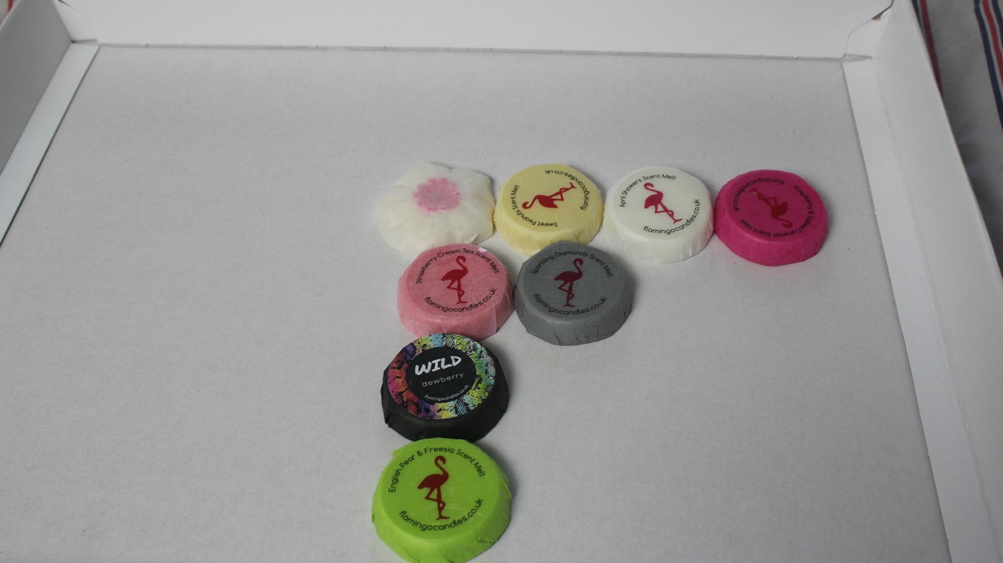 Flamingo Candles The Melt Crowd April 2016 A picture of the contents of the Flamingo Candles Melt Crowd April 2016 box arranged in the shape of the letter F.