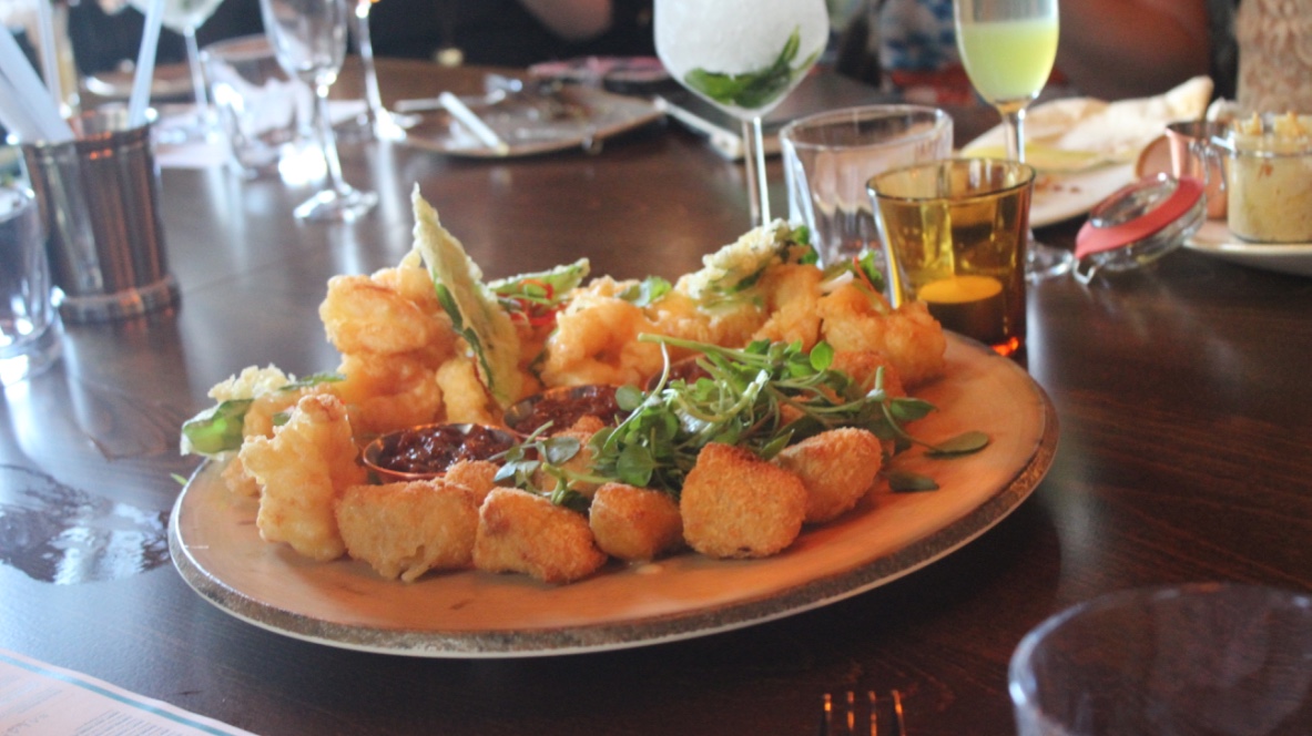 some Tempura King Prawns on a plate.