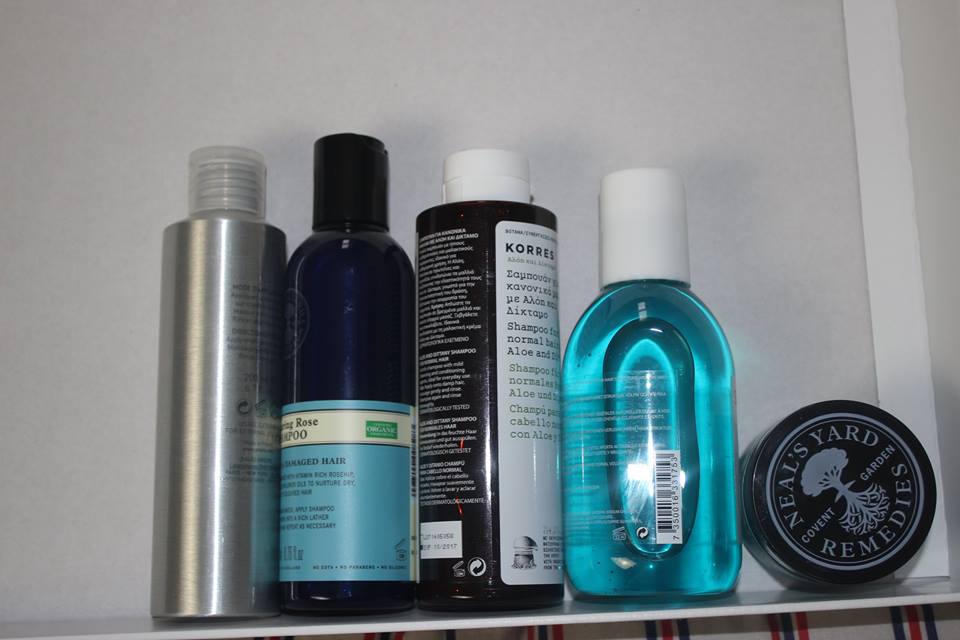 a picture of four different shampoo bottles, and a small glass tub.