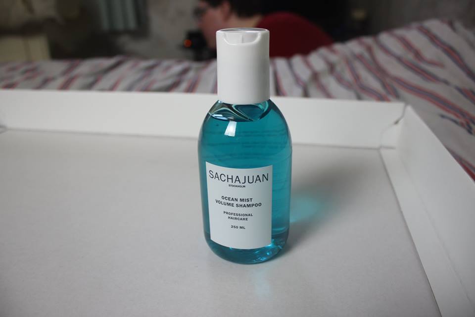 A tall shampoo bottle that's wide at the bottom, and thin at the top.