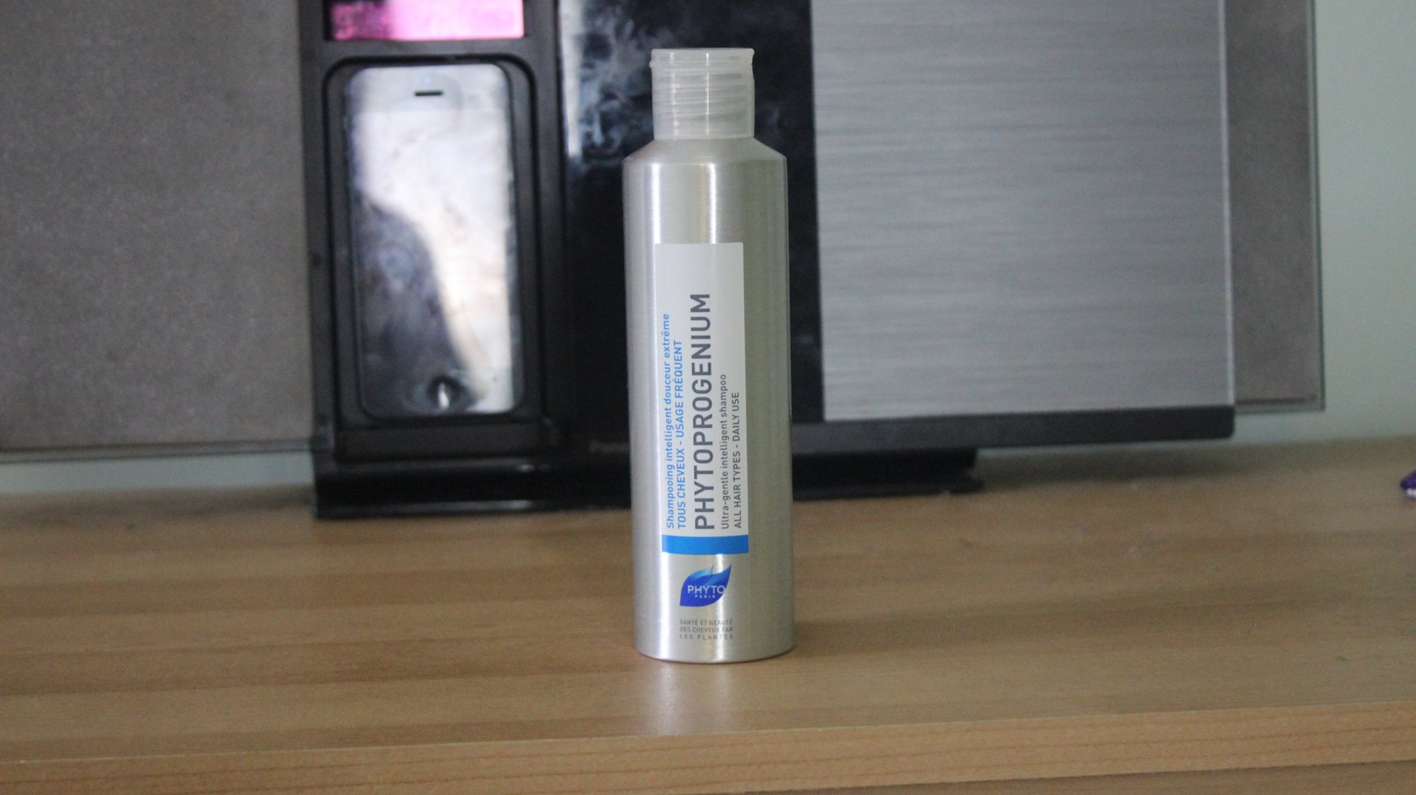 A tall glass bottle of shampoo.