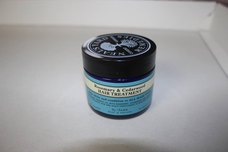 a small glass tub with a shiny lid.