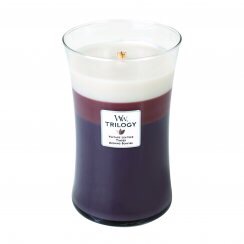 A large glass jar containing three different coloured wax