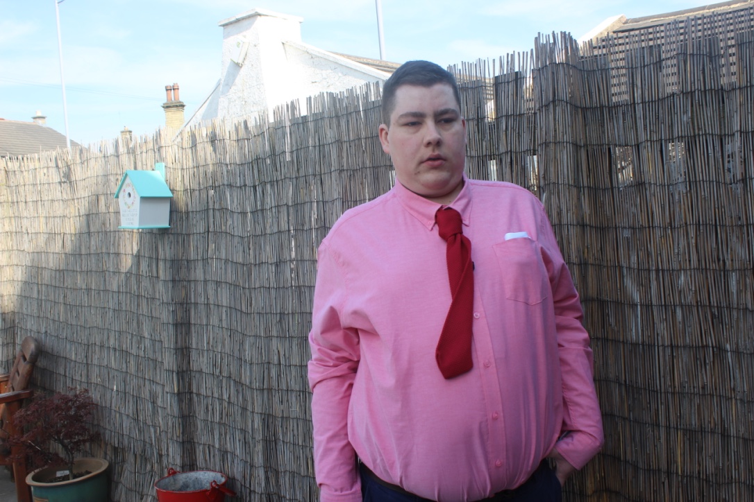 Me wearing a pink shirt, a red tie. a red pocket square, and a pair of cufflinks.