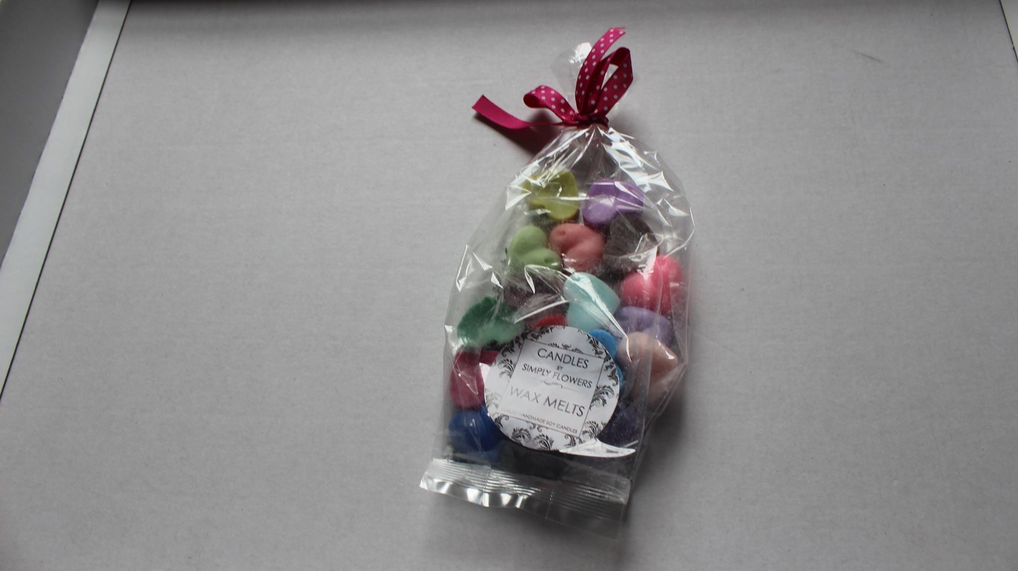 A ribbon tied plastic bag containing 20 heart shaped wax melts.