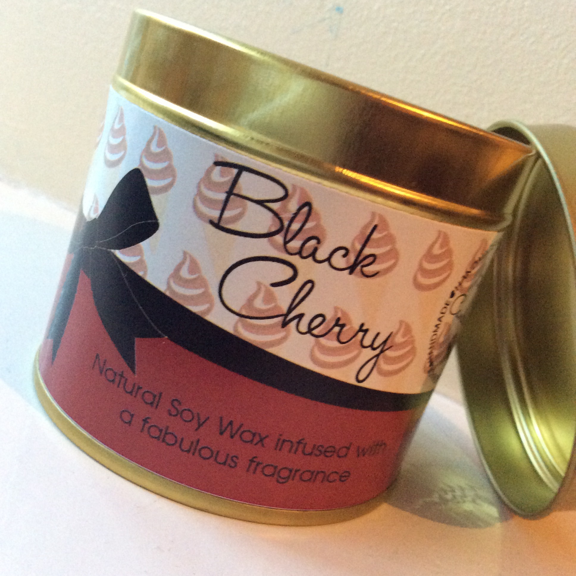 A short, fat, candle tin.