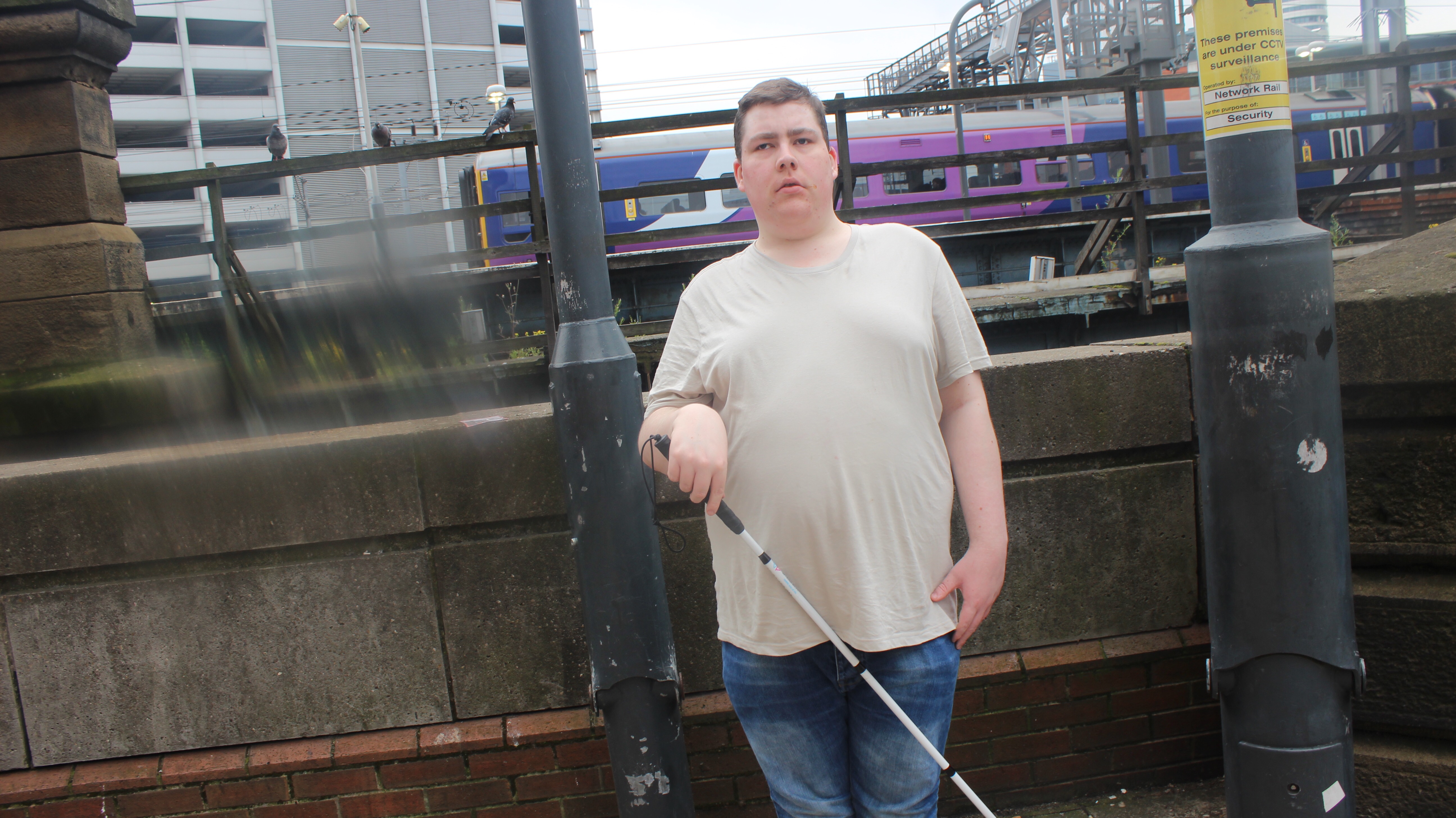 me holding a white cane.