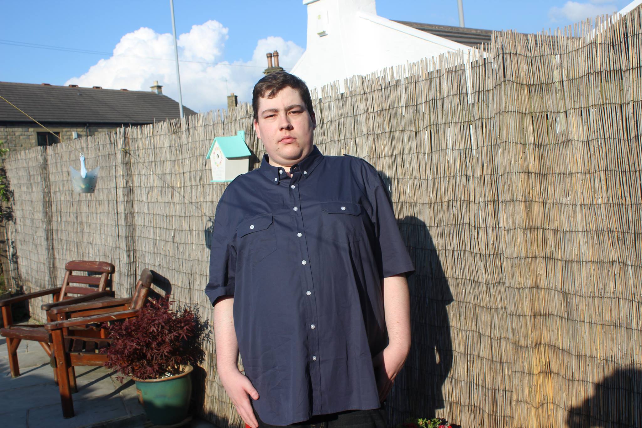A person wearing a Navy military style short sleeved shirt.